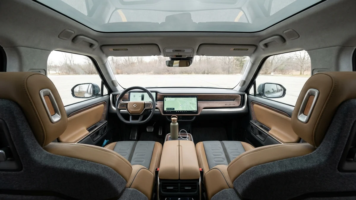 Rivian R2 interior dashboard with center touchscreen and panoramic roof